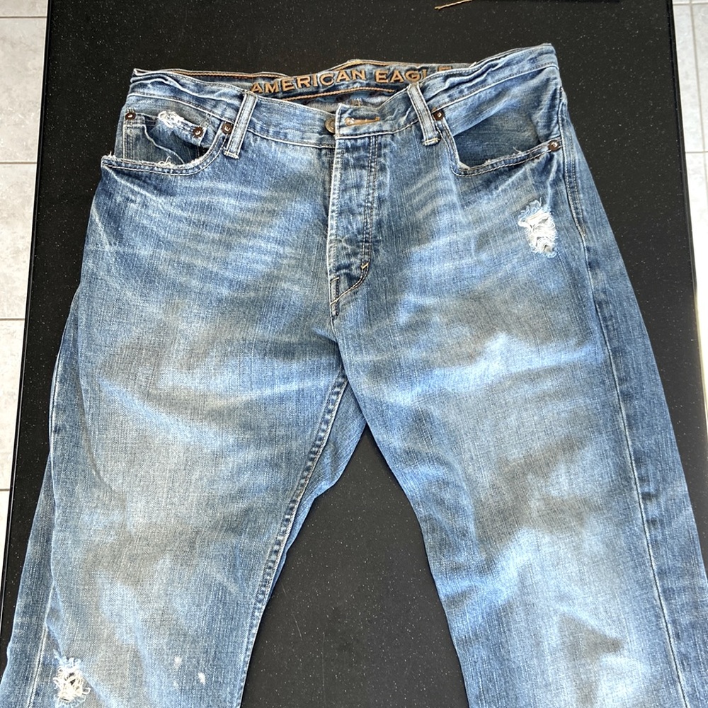 American Eagle size 33/32 low rise boot cut. Button fly. Factory ripped